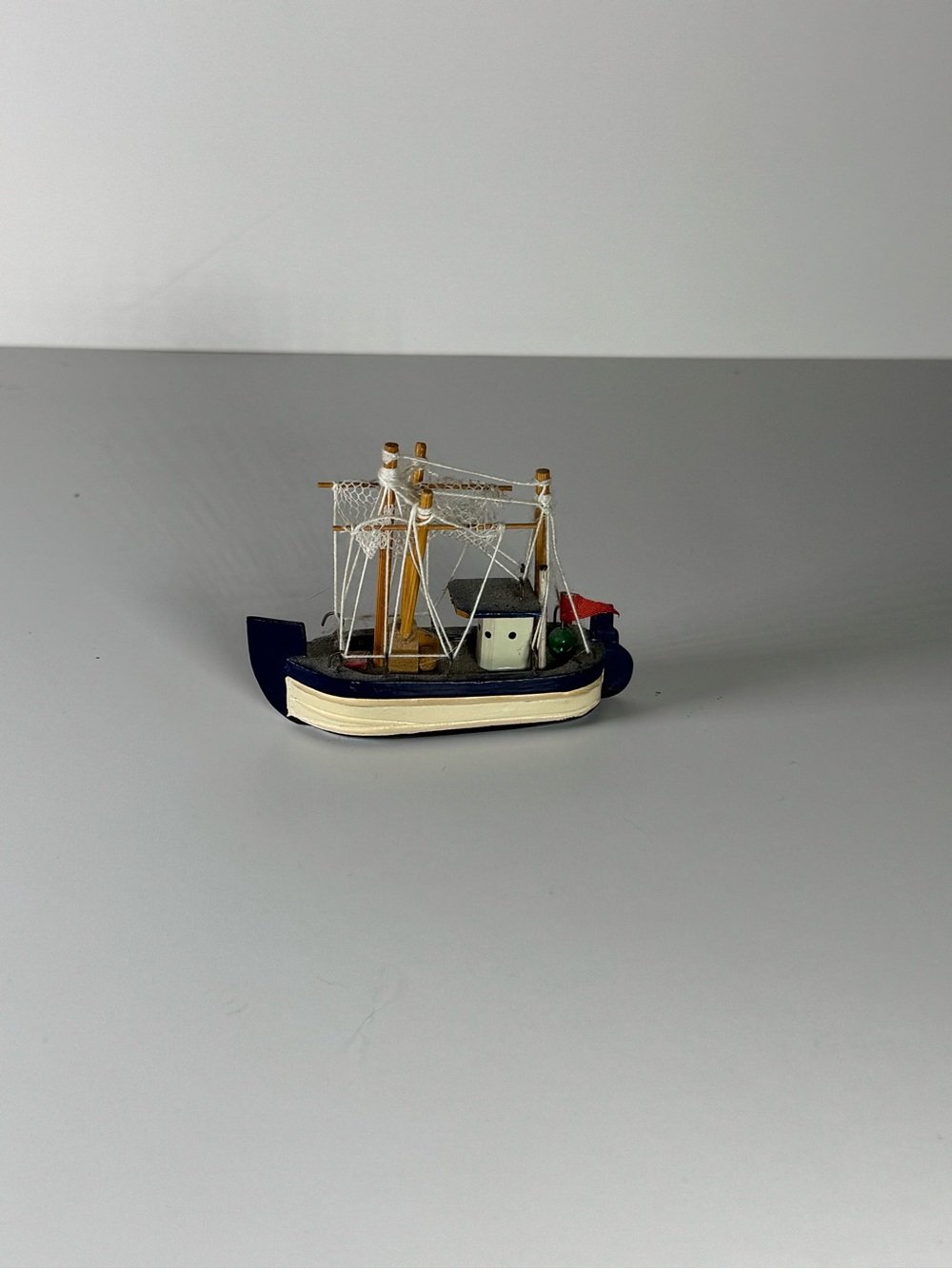 Miniature Fishing Boat Model with Nets and Flag